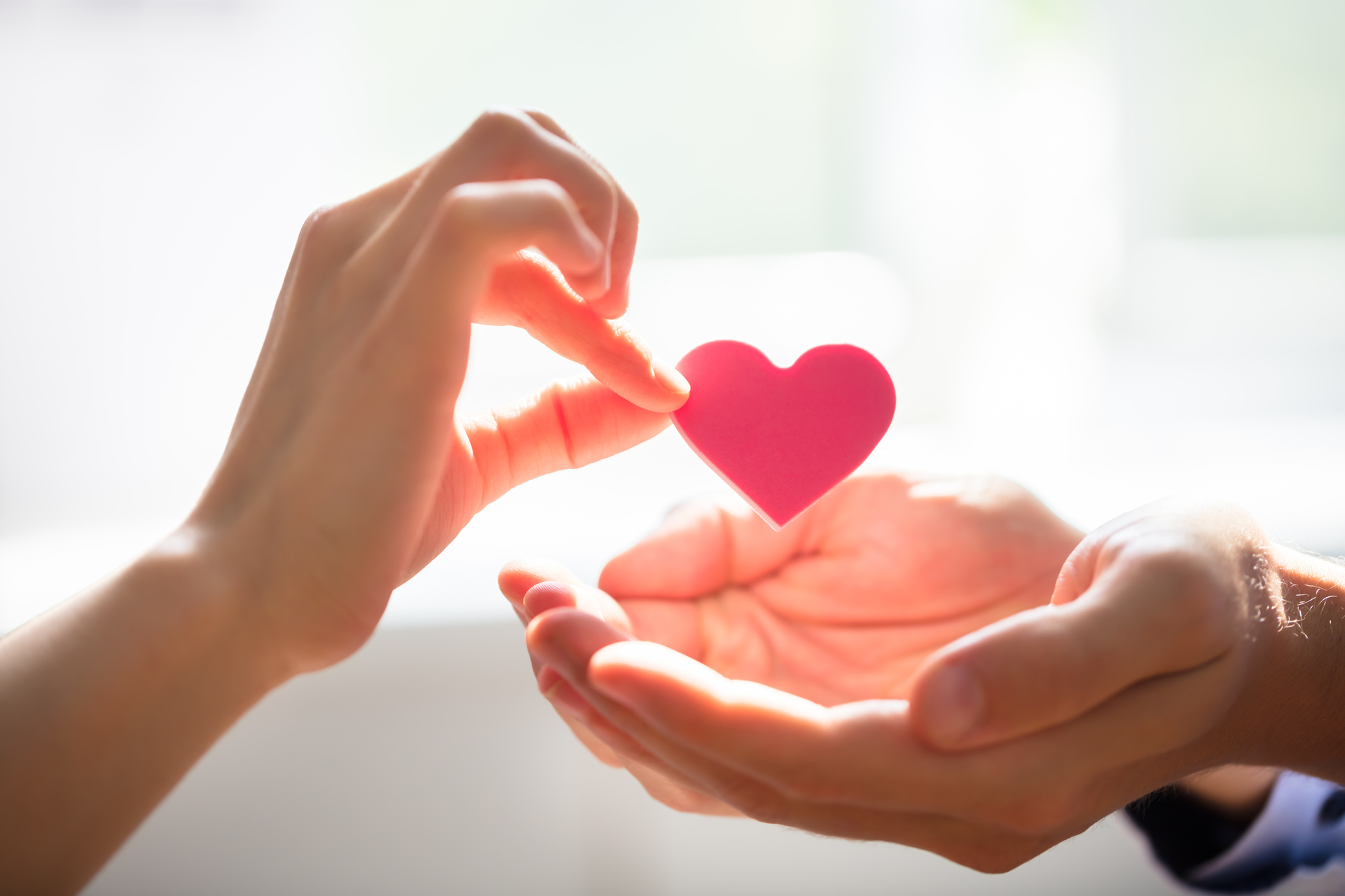 Woman Giving Heart On Man’s Hand